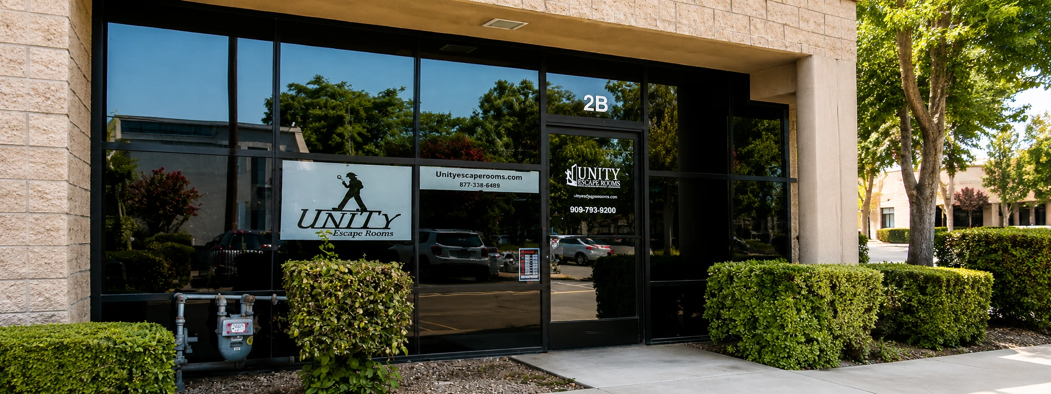Unity Escape Rooms in Redlands California with modern storefront entrance and landscaped outdoor walkway