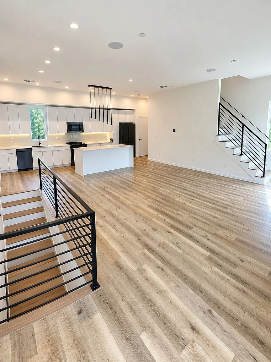 Open-concept living room and kitchen with island and hardwood floors