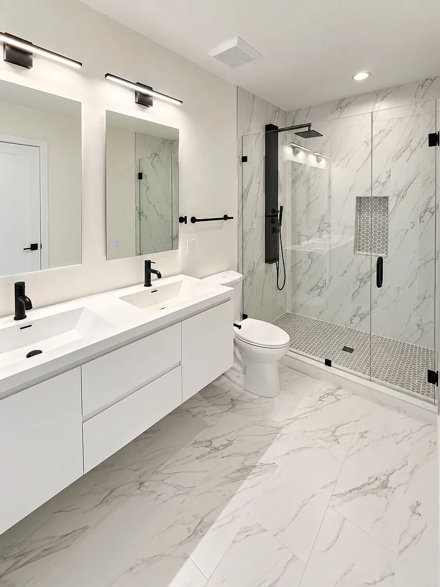 Primary bathroom with double vanity and walk-in marble shower