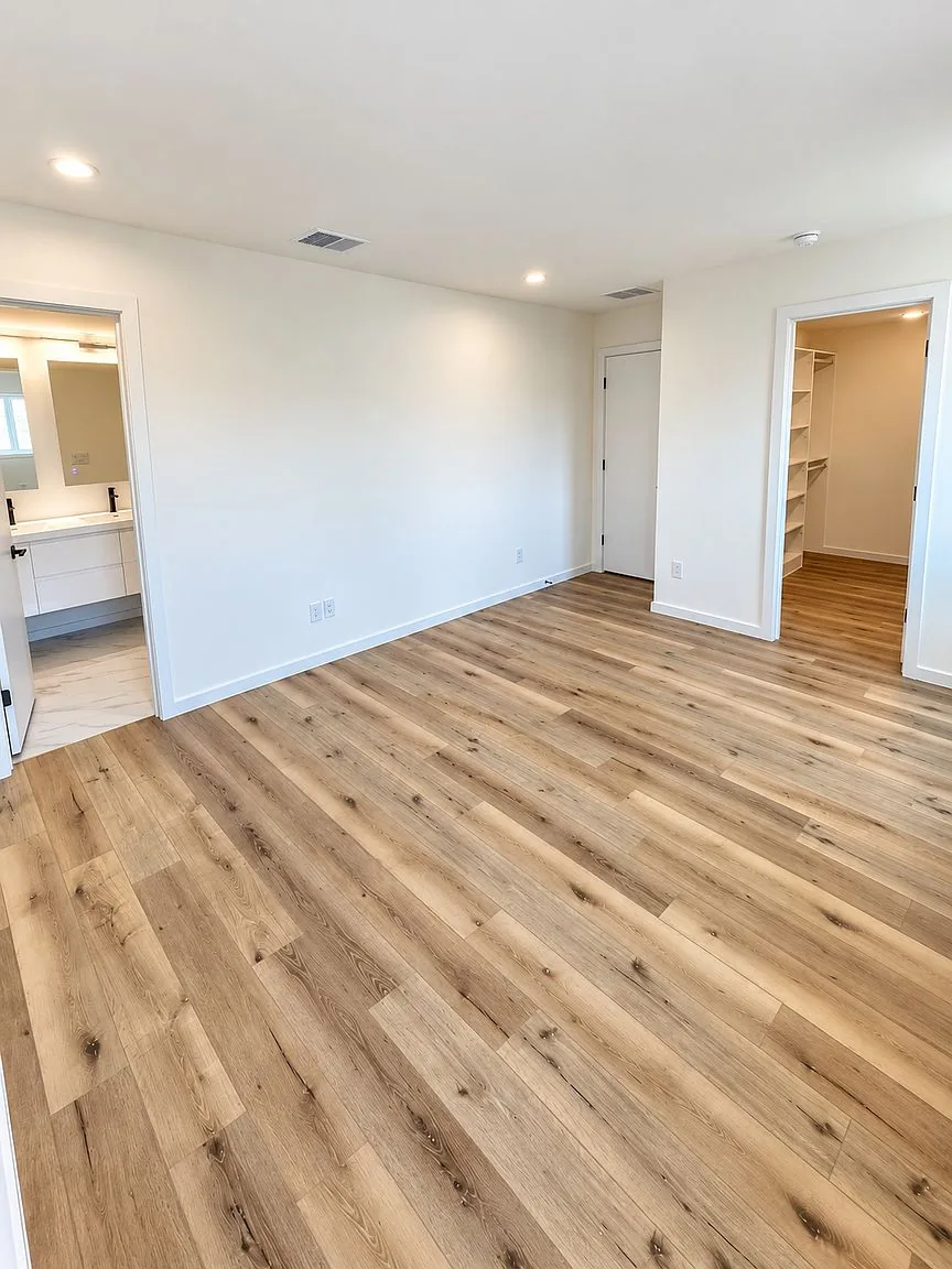 Primary bedroom with hardwood floors