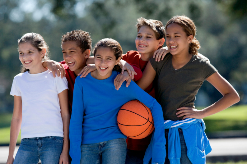 kids grouped together with basketball