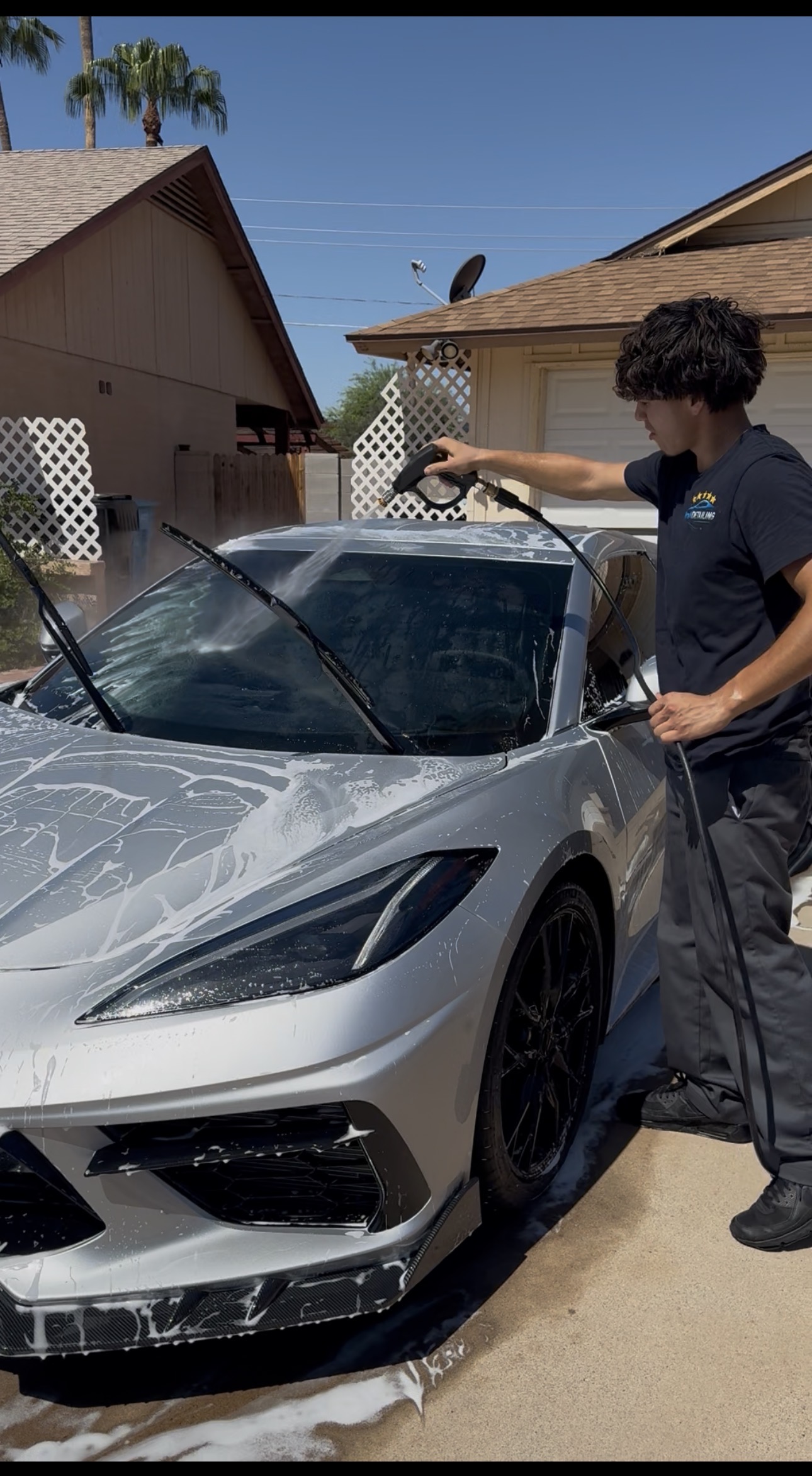 RnM Detailing team member foam washing a Corvette