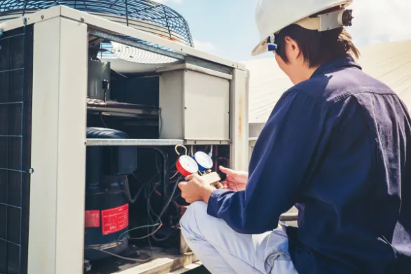 HVAC technician servicing a unit