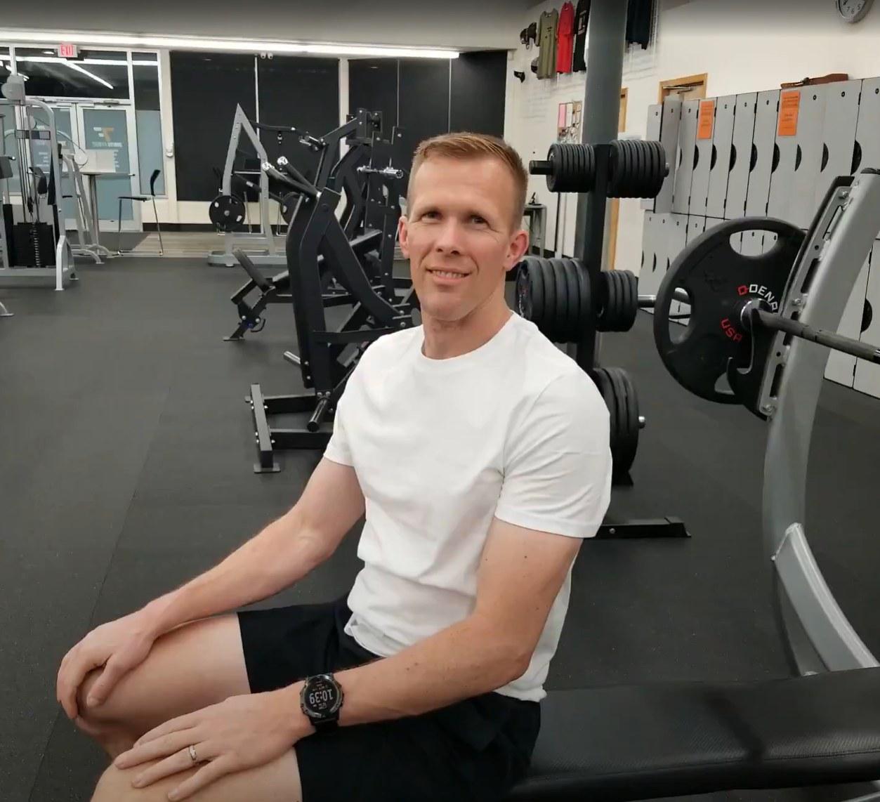 Evan Jensen sitting on a bench in the gym