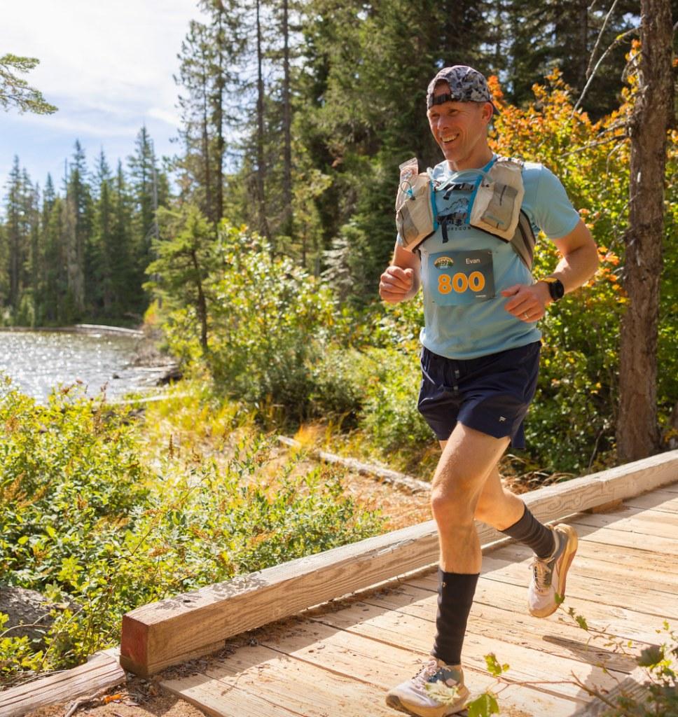 Evan Jensen running a trail race on a wooden boardwalk