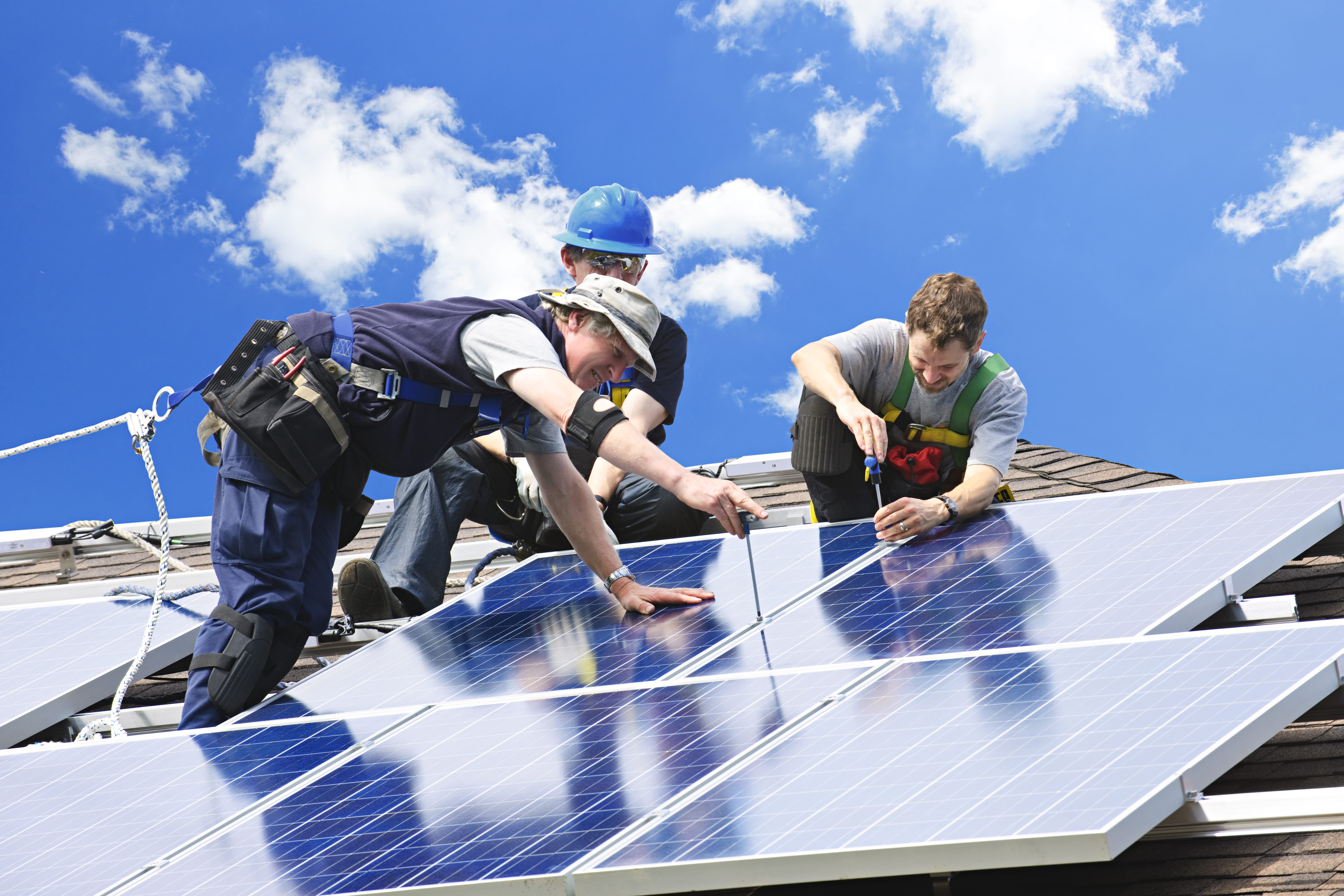 group of contractors installing solar panels