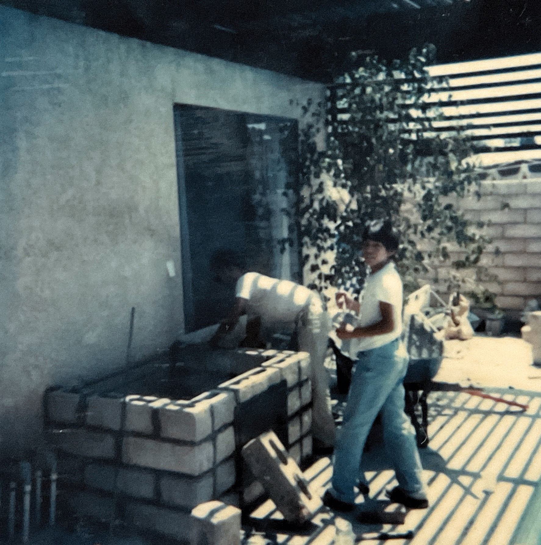 Gus Gonzalez building an outdoor barbecue at age 14 in 1984
