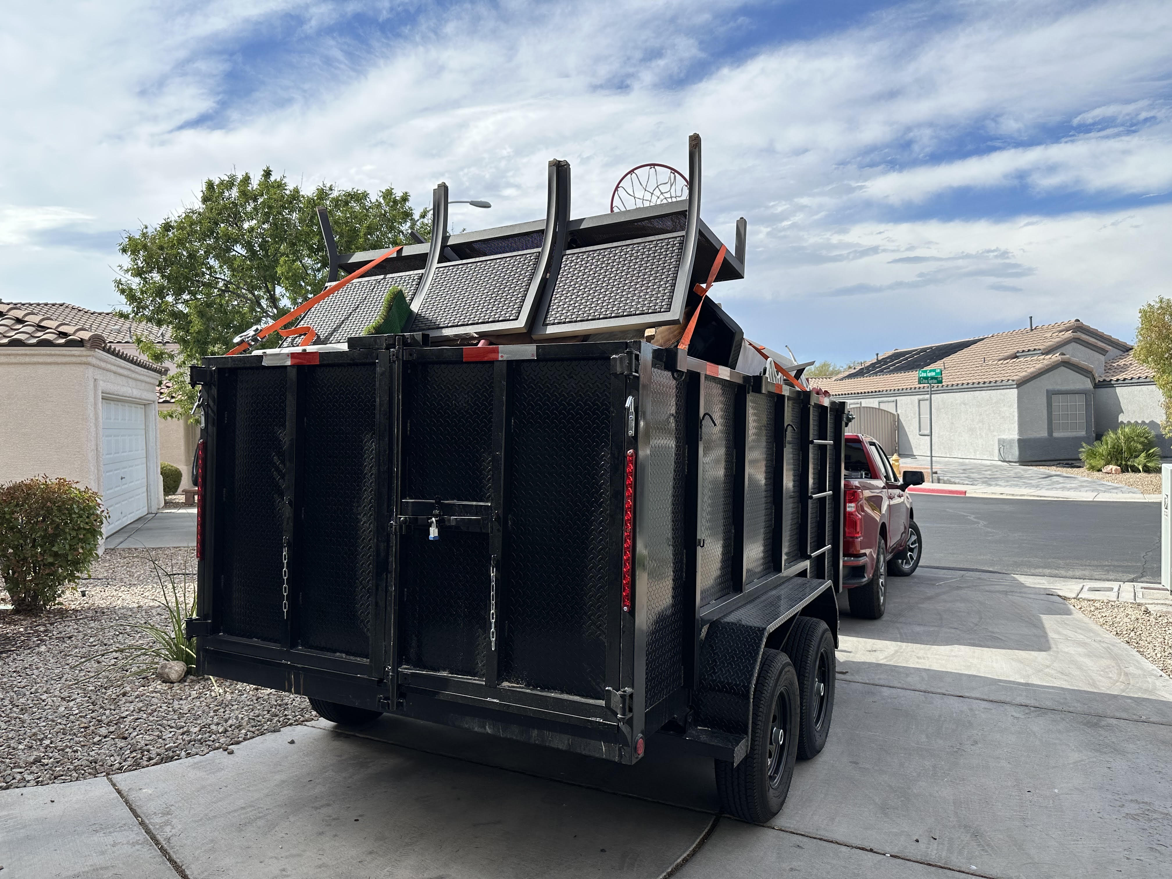 Professional crew loading a couch into a van for residential junk removal