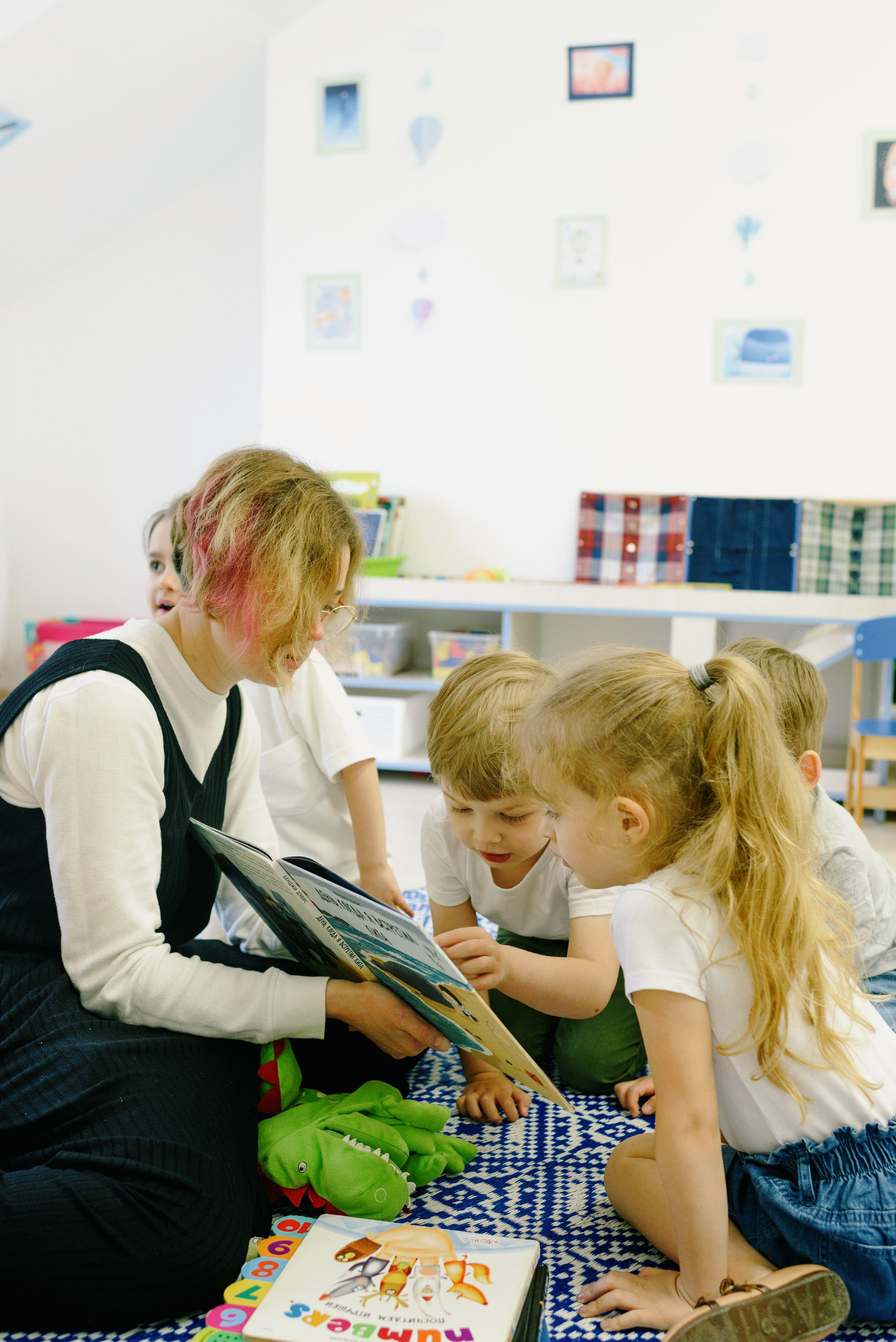 Teacher reading with children in a classroom