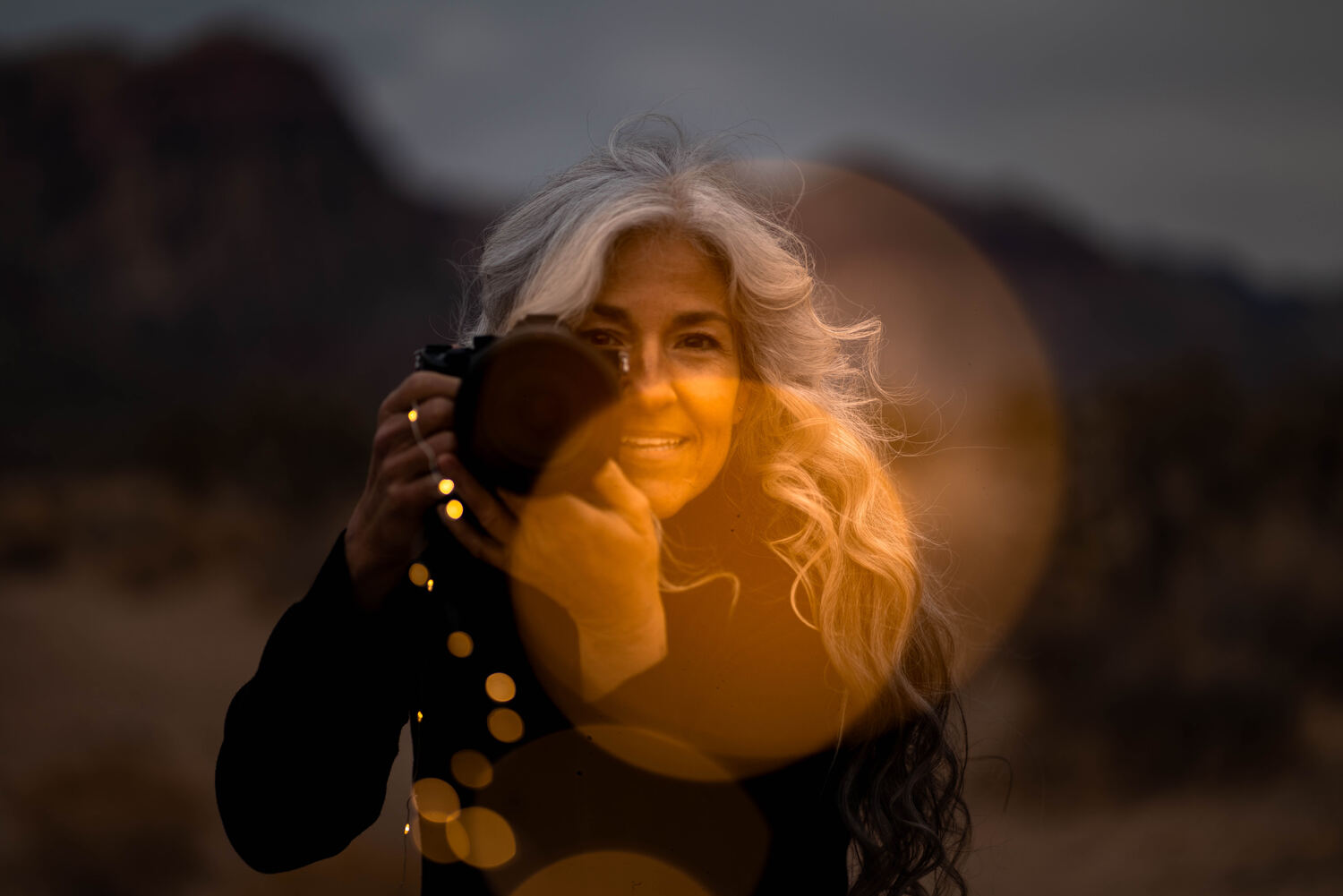 Jennifer Flynn photographing at golden hour, camera raised