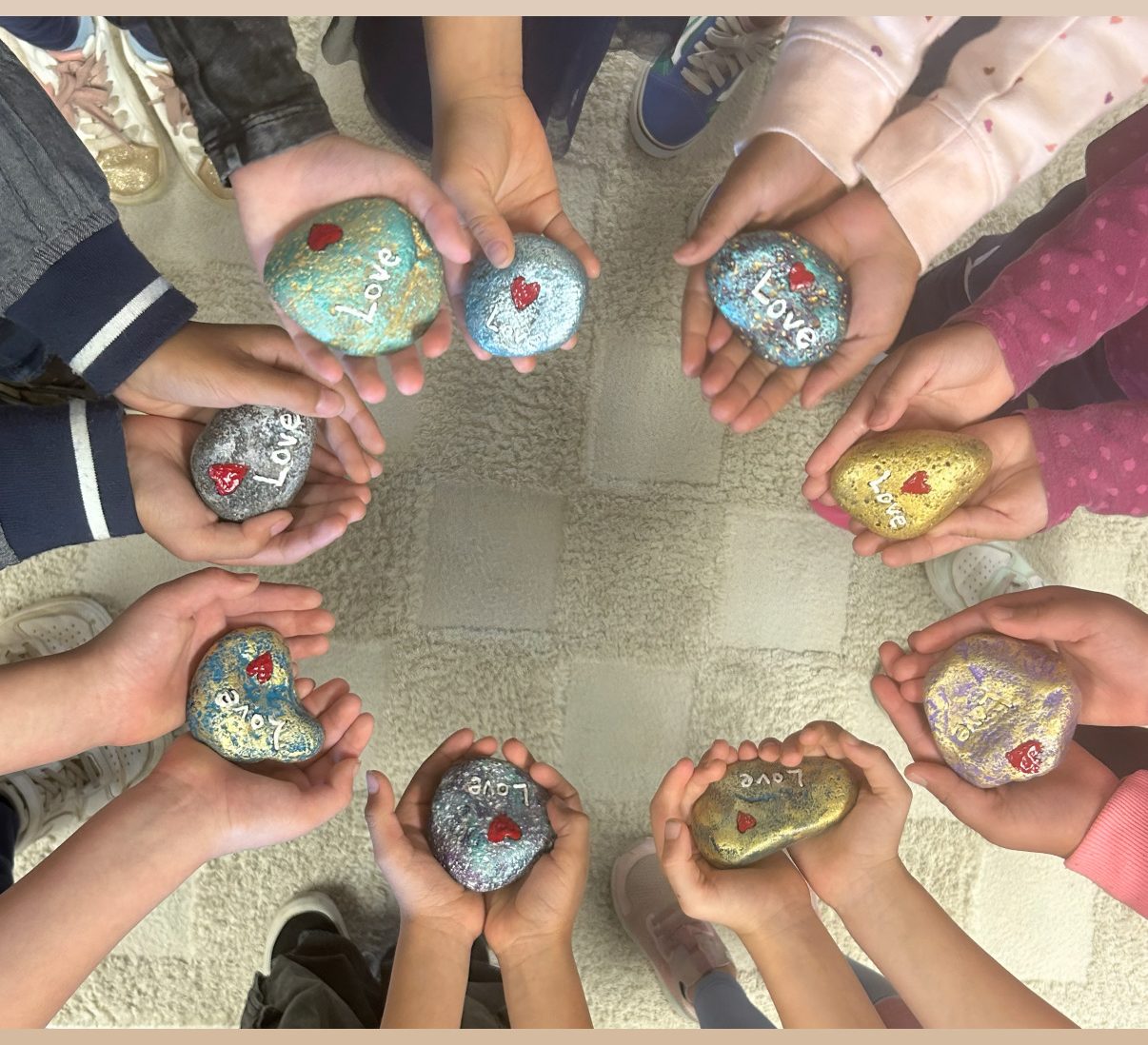St. Peter's students holding painted Love stones