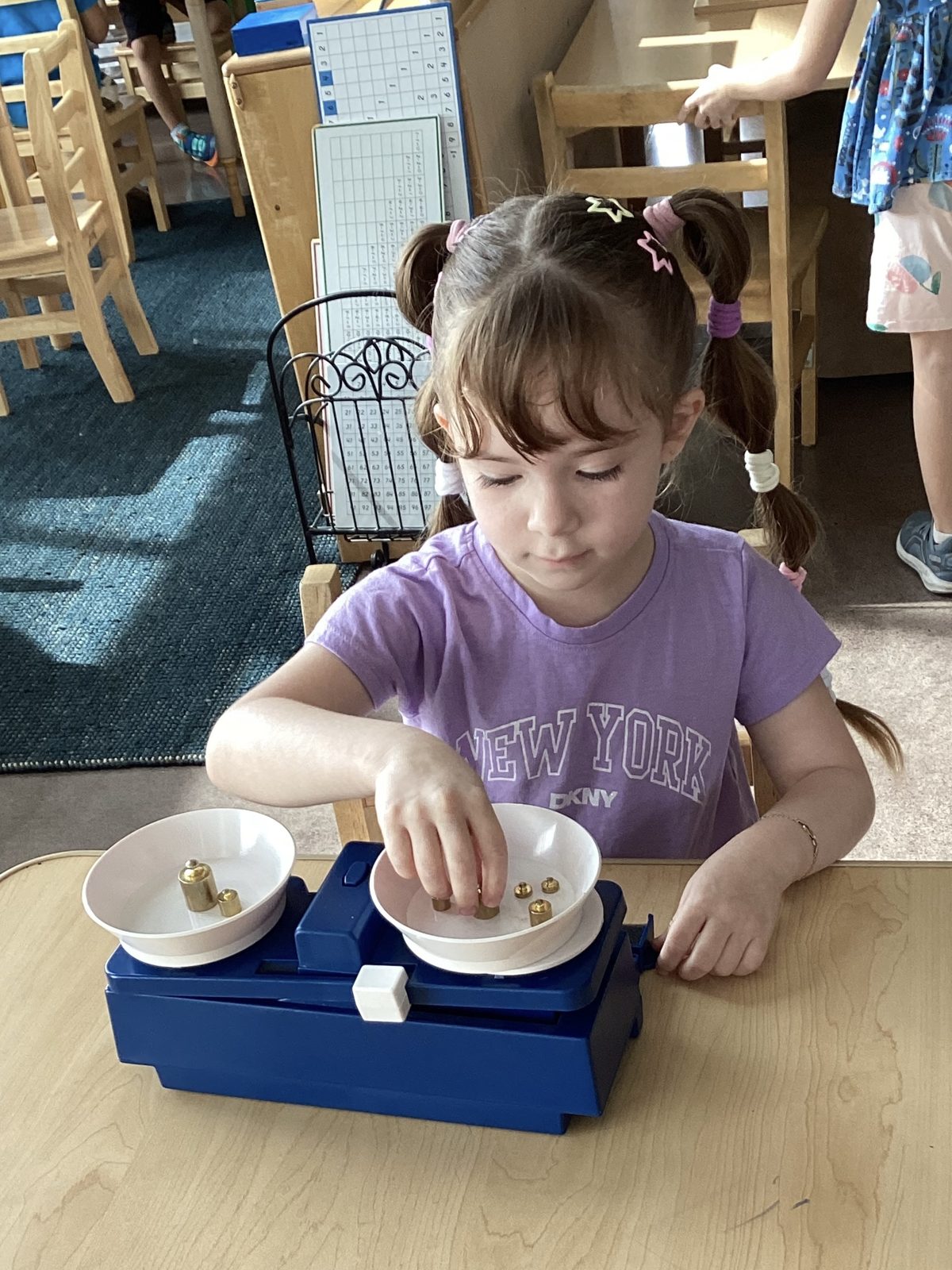 A St. Peter's elementary student working with the Montessori balance scale