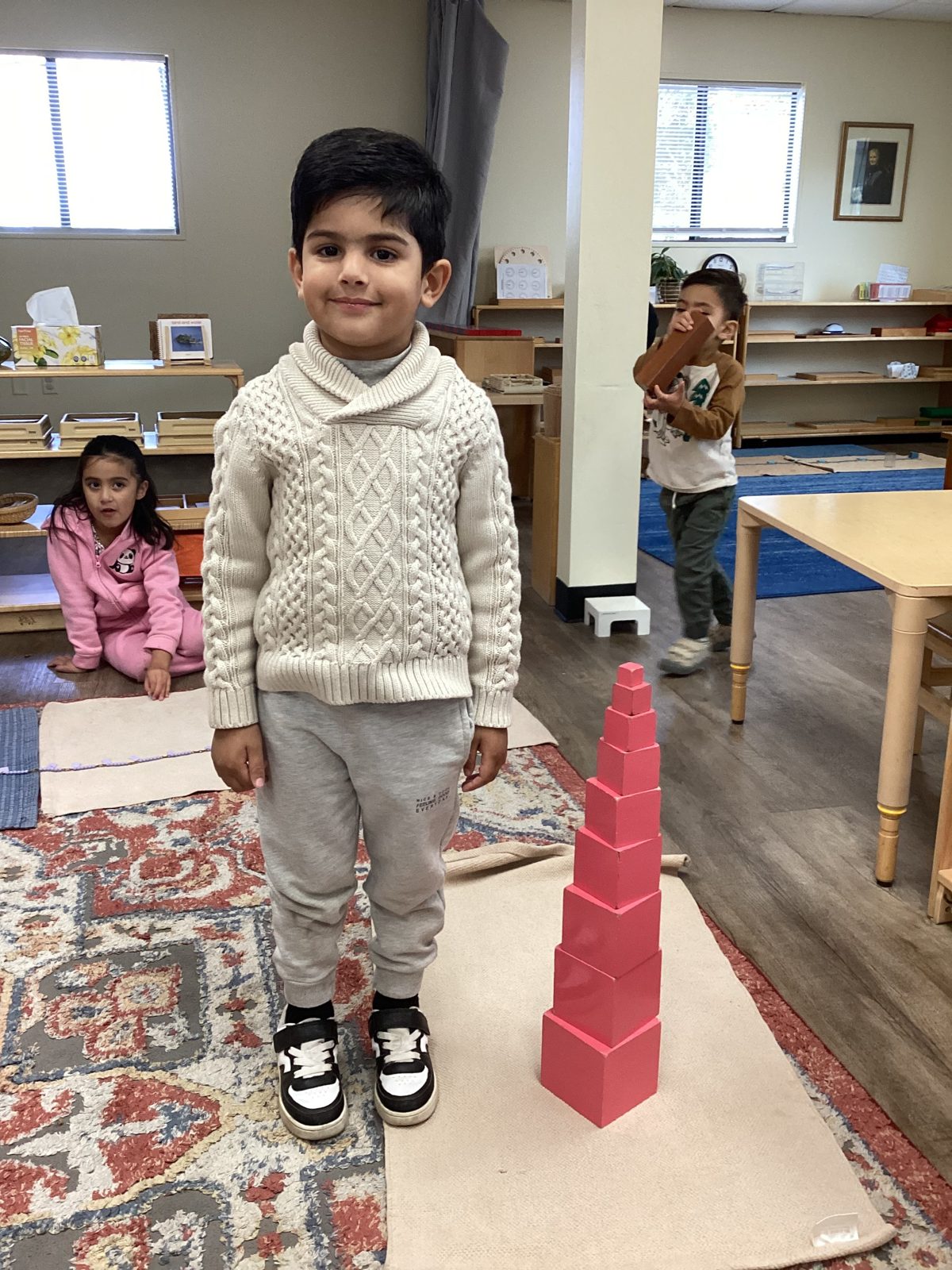 A St. Peter's child building the Montessori Pink Tower