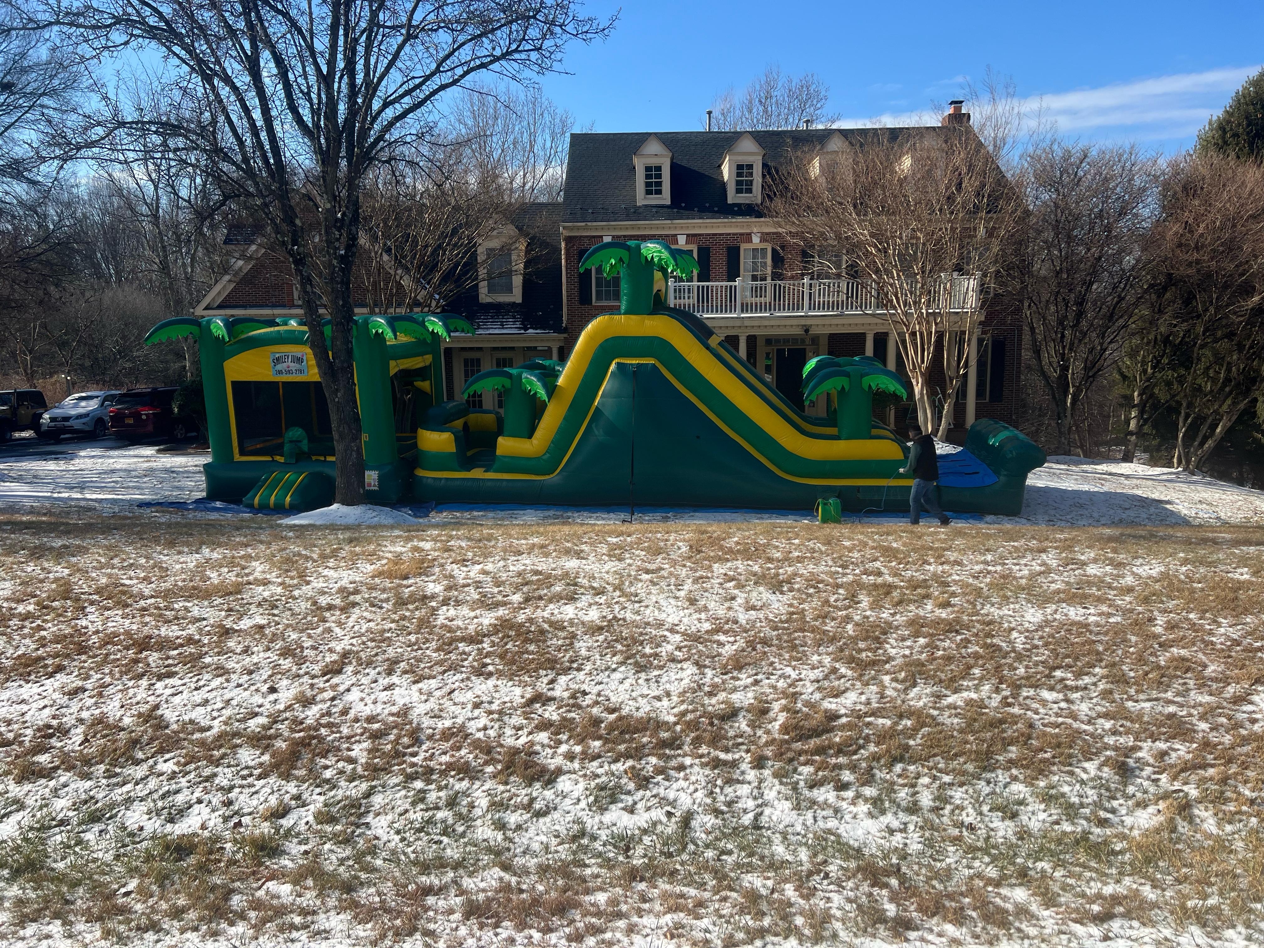 56' L Tropical Obstacle Combo Dual Slide rental from Smiley Jump LLC in Germantown, MD, featuring a tropical inflatable obstacle course with dual slides for parties and events