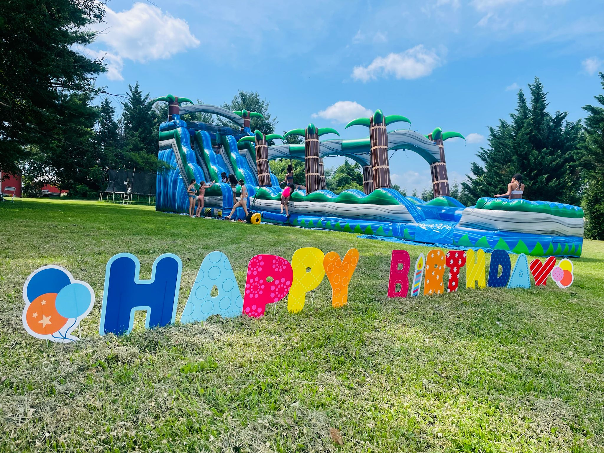 20 foot Tropical Dual Slip and Slide inflatable water slide rental from Smiley Jump, serving Germantown, Maryland, Washington DC, and Northern Virginia for birthday parties, school events, church gatherings, daycare celebrations, and summer community events