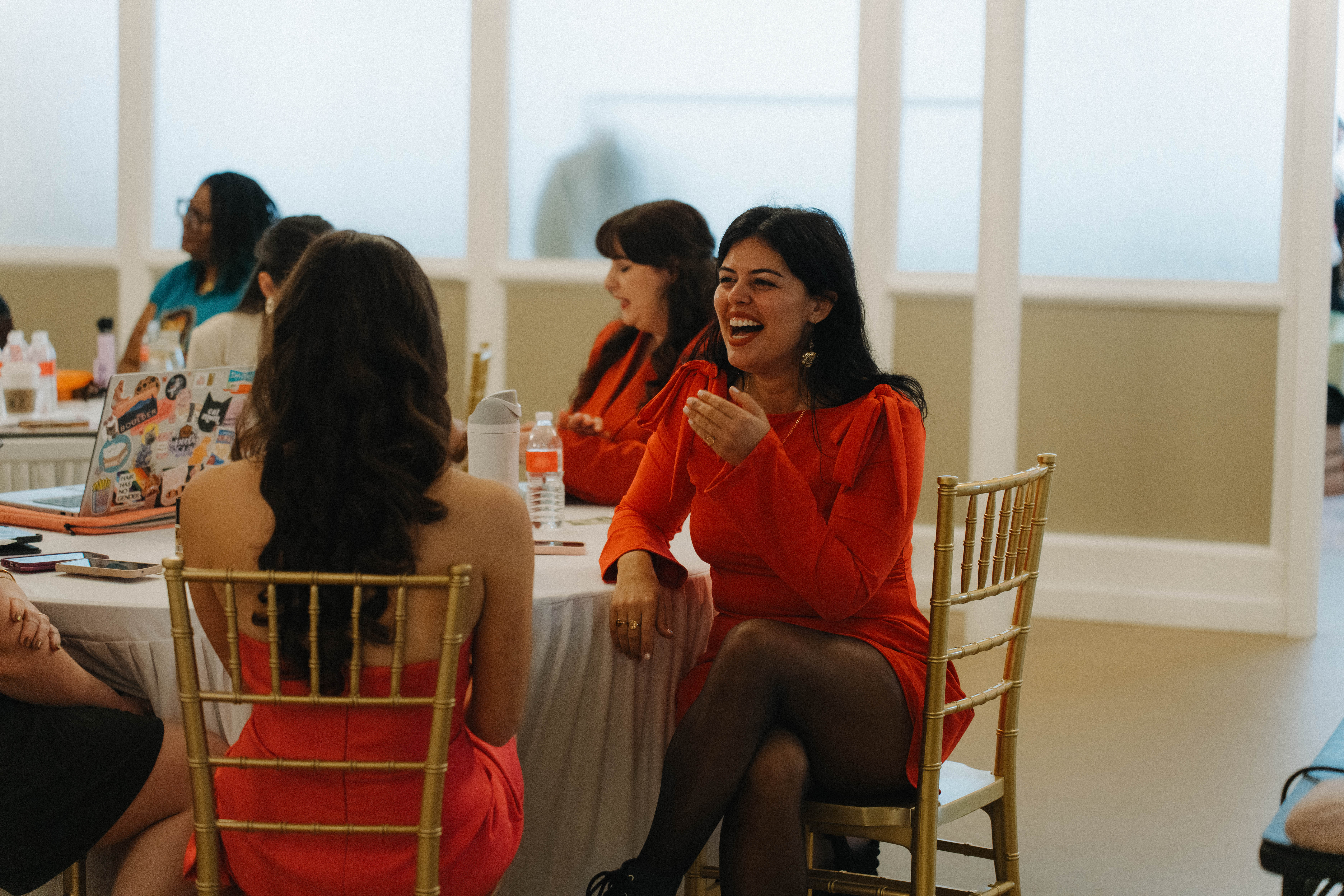 Women laughing and building relationships at a BESTIES gathering