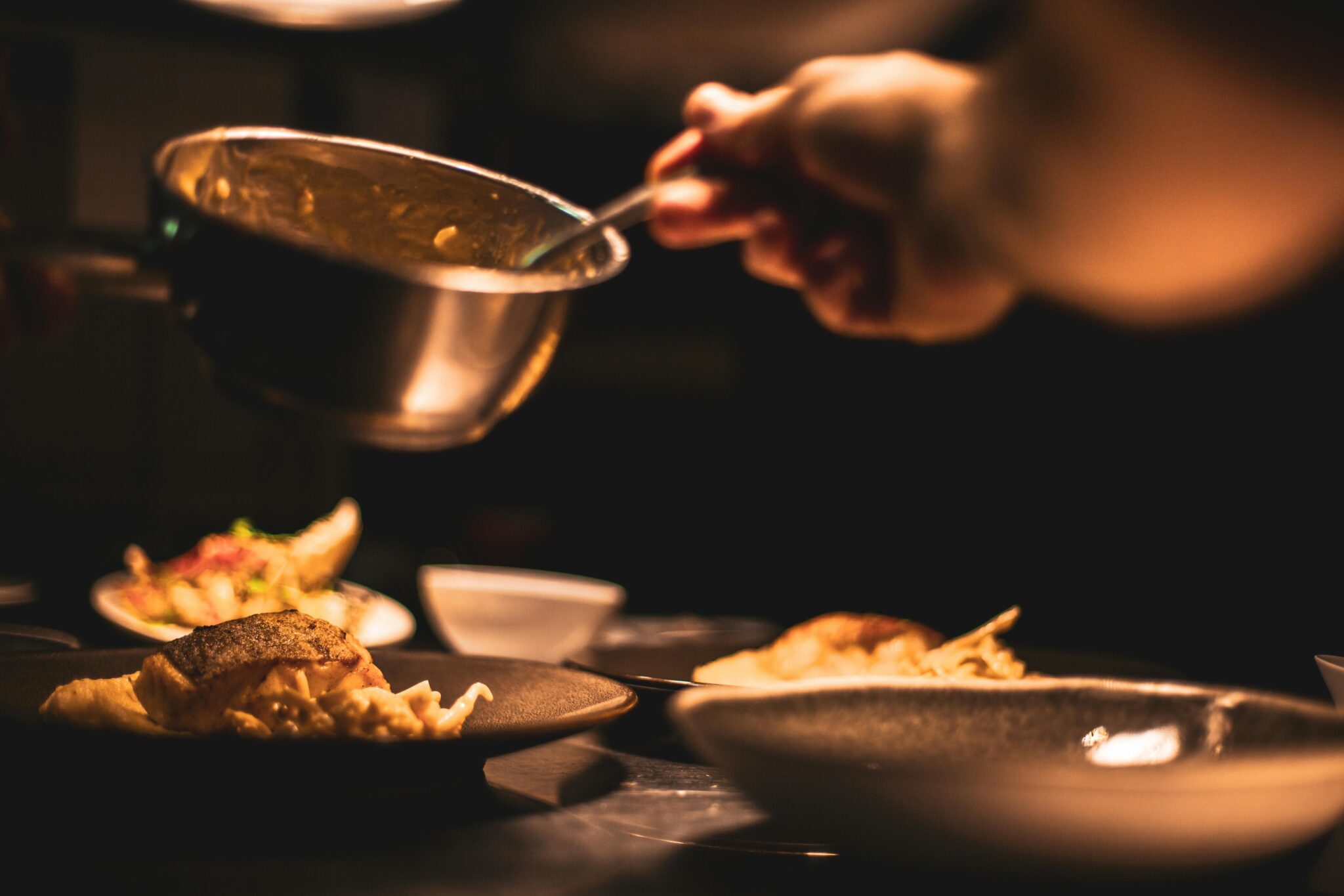 Chef plating a dish in a commercial kitchen