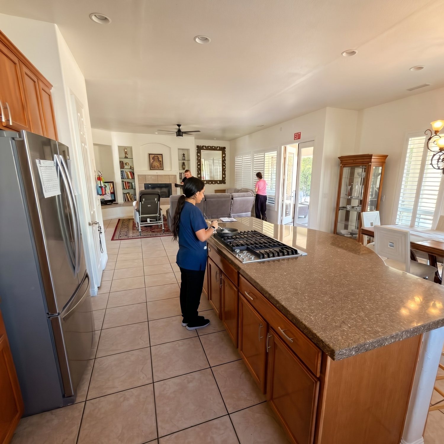 A caregiver cooking in the kitchen of the Cathedral City home