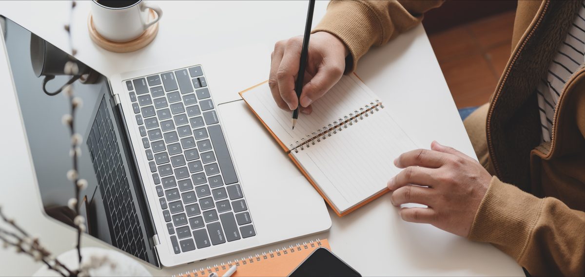 Planning notes beside a laptop