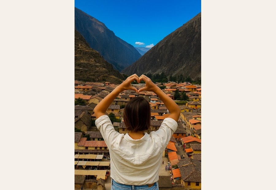 Sarah making a heart shape with her hands toward a mountain view