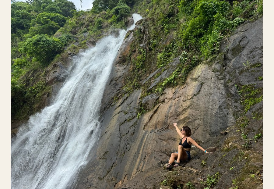 Sarah Carpenter beside a waterfall