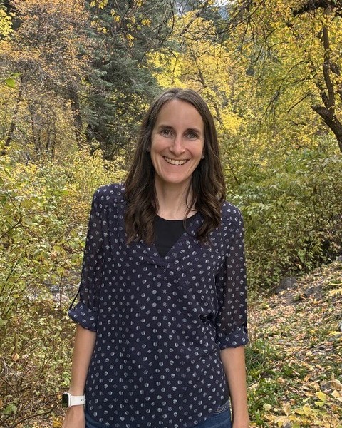 Heidi Phipps, founder of Phipps Alliance, outdoors among fall leaves