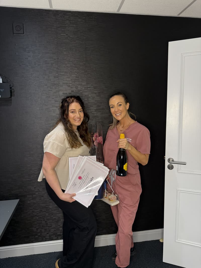 Nikita holding her certificates of achievement