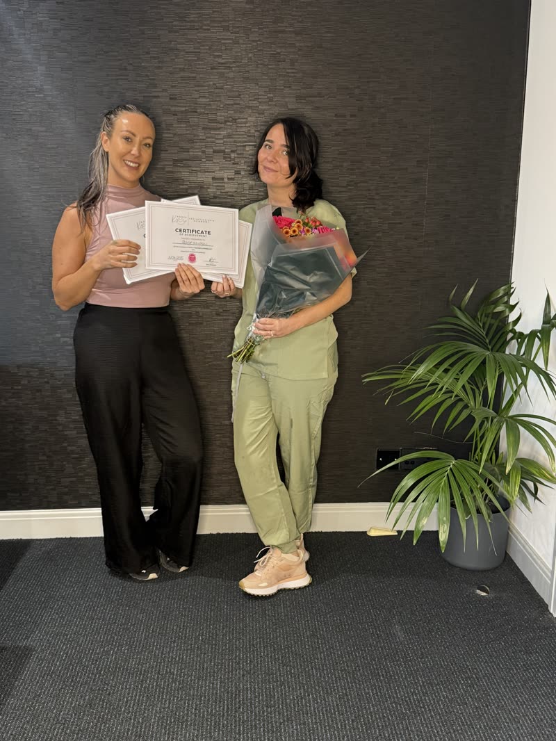 Robbie holding her certificates of achievement