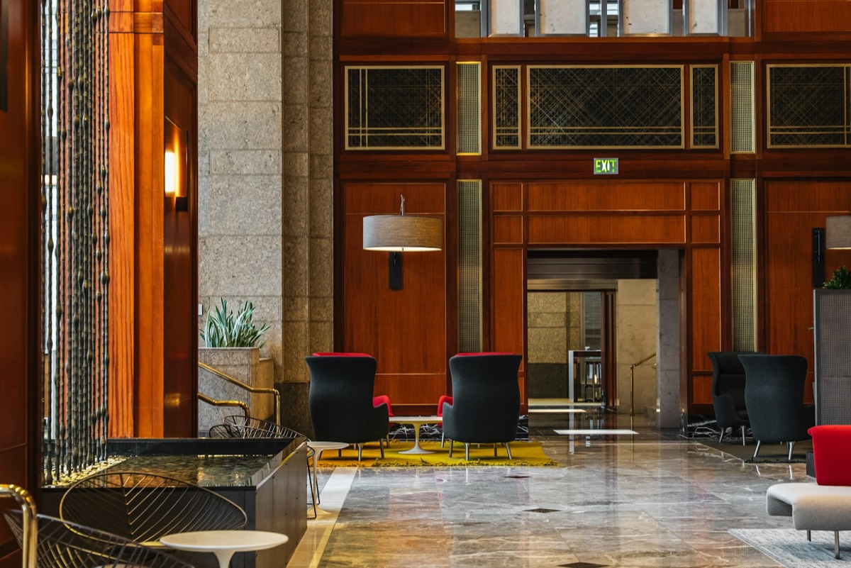 A quiet hotel lobby in warm wood and soft light