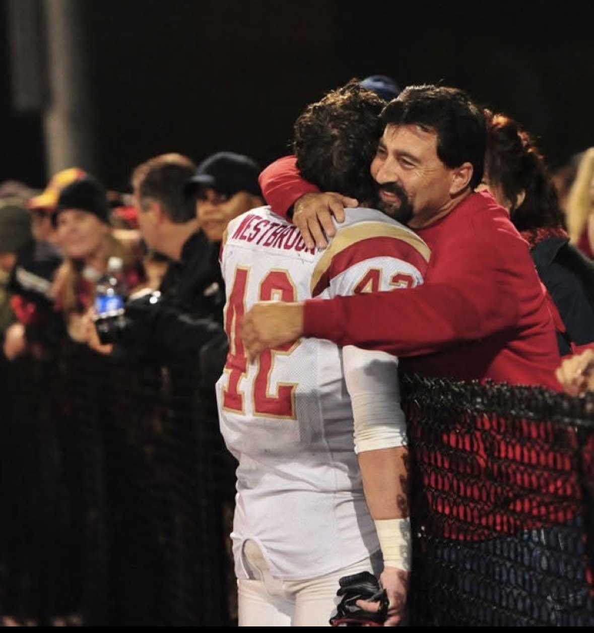 Hugging my dad on the football field