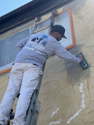 Stucco repair and restoration on residential exterior wall