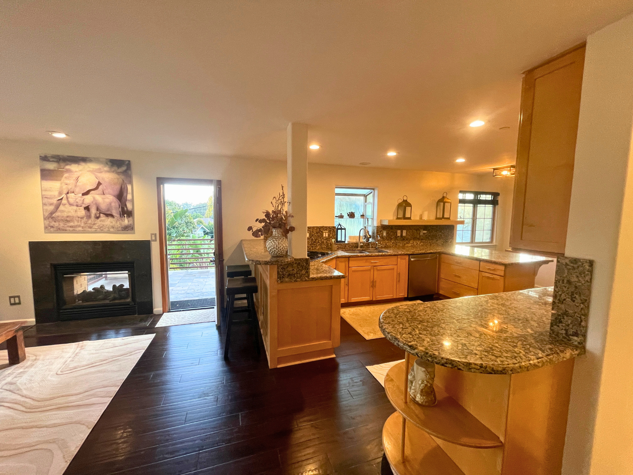 Chef's kitchen with granite countertops and a dual sided indoor outdoor fireplace