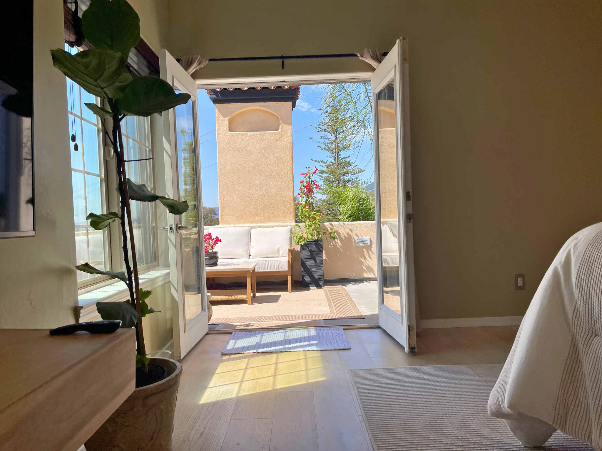 Primary suite with white French oak flooring and French doors to the terrace