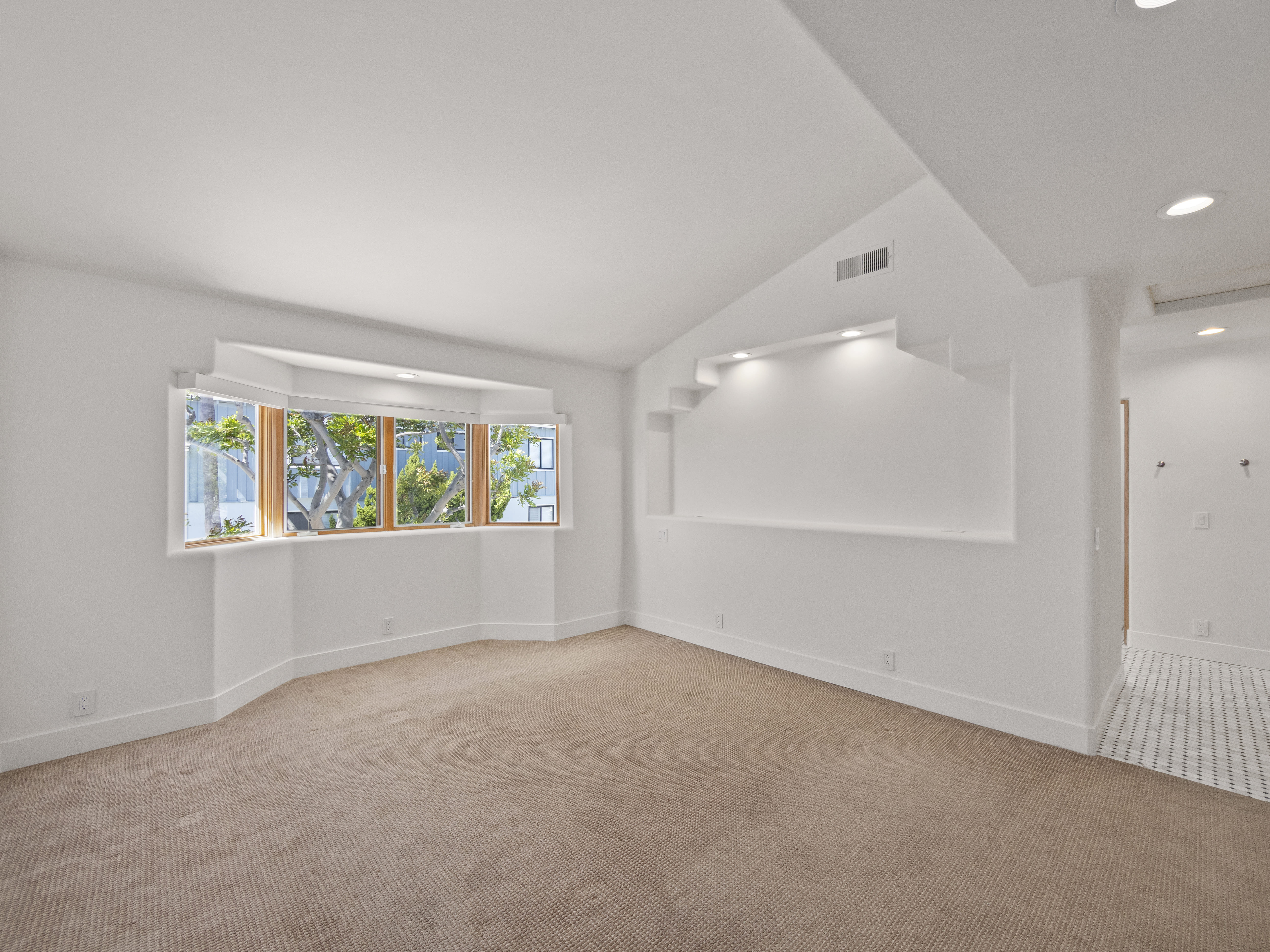 Grand living room with soaring ceilings and natural light