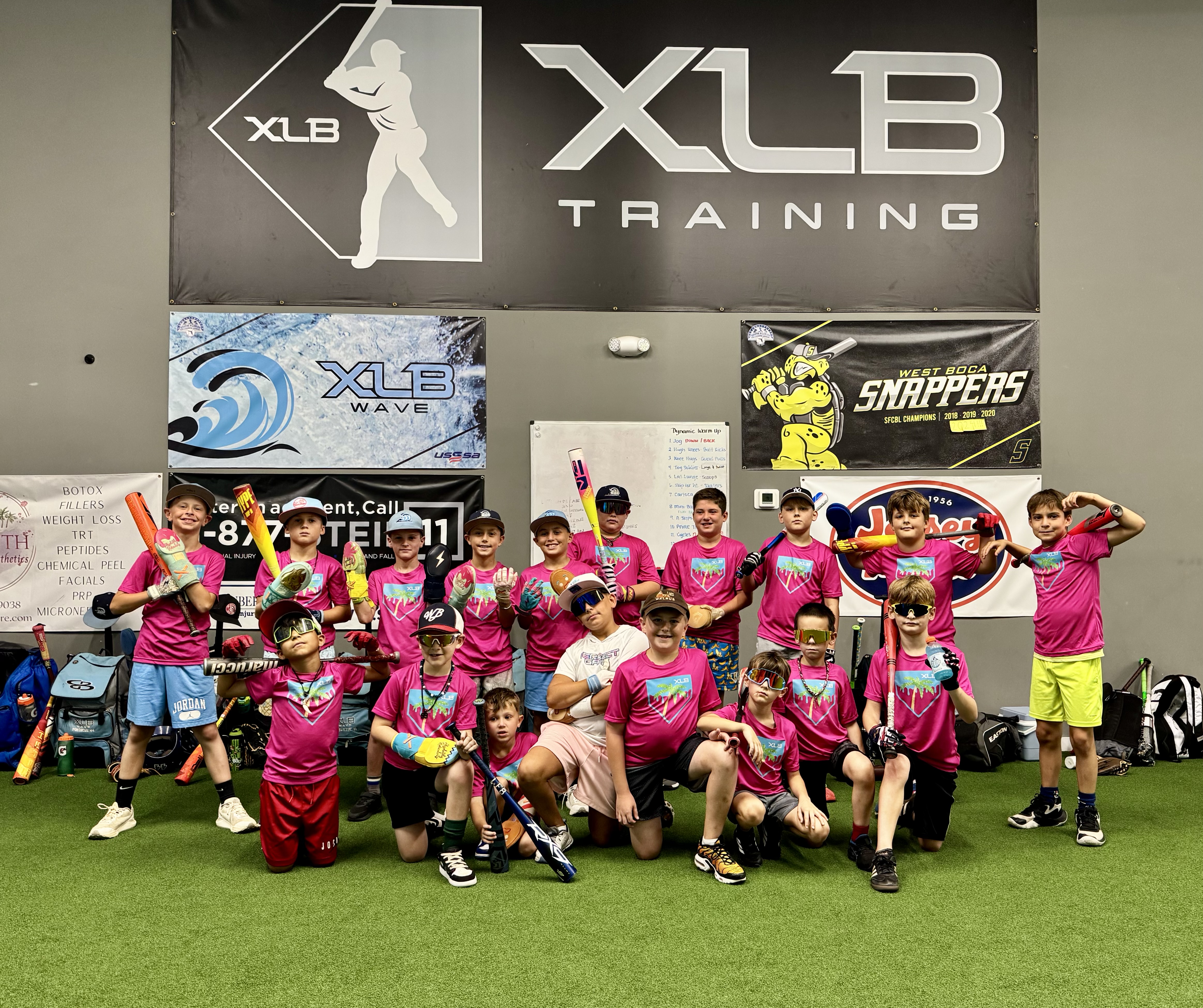 Group of young campers in XLB Training camp shirts at the Boynton Beach facility during a no-school baseball camp