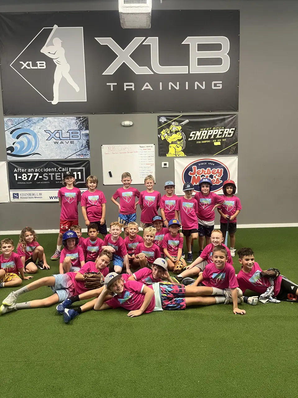 Group of young campers in XLB Training camp shirts at the Boynton Beach facility during a no-school baseball camp