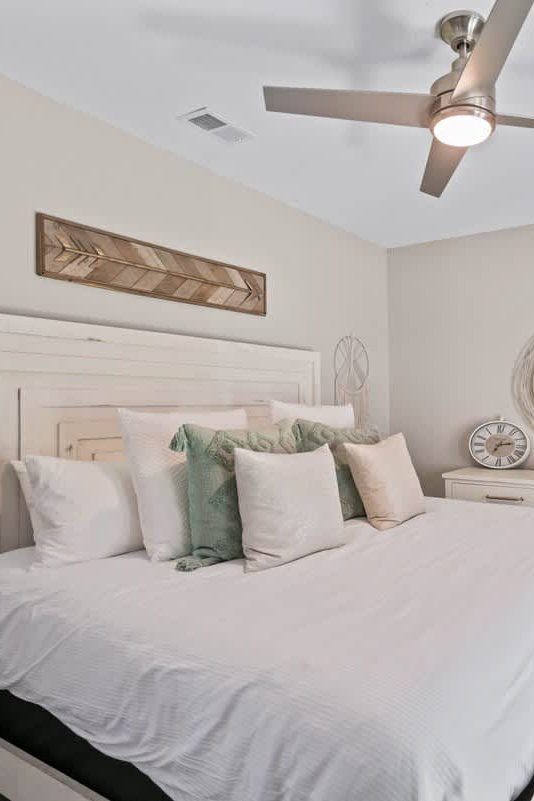 woman setting sheets on bed