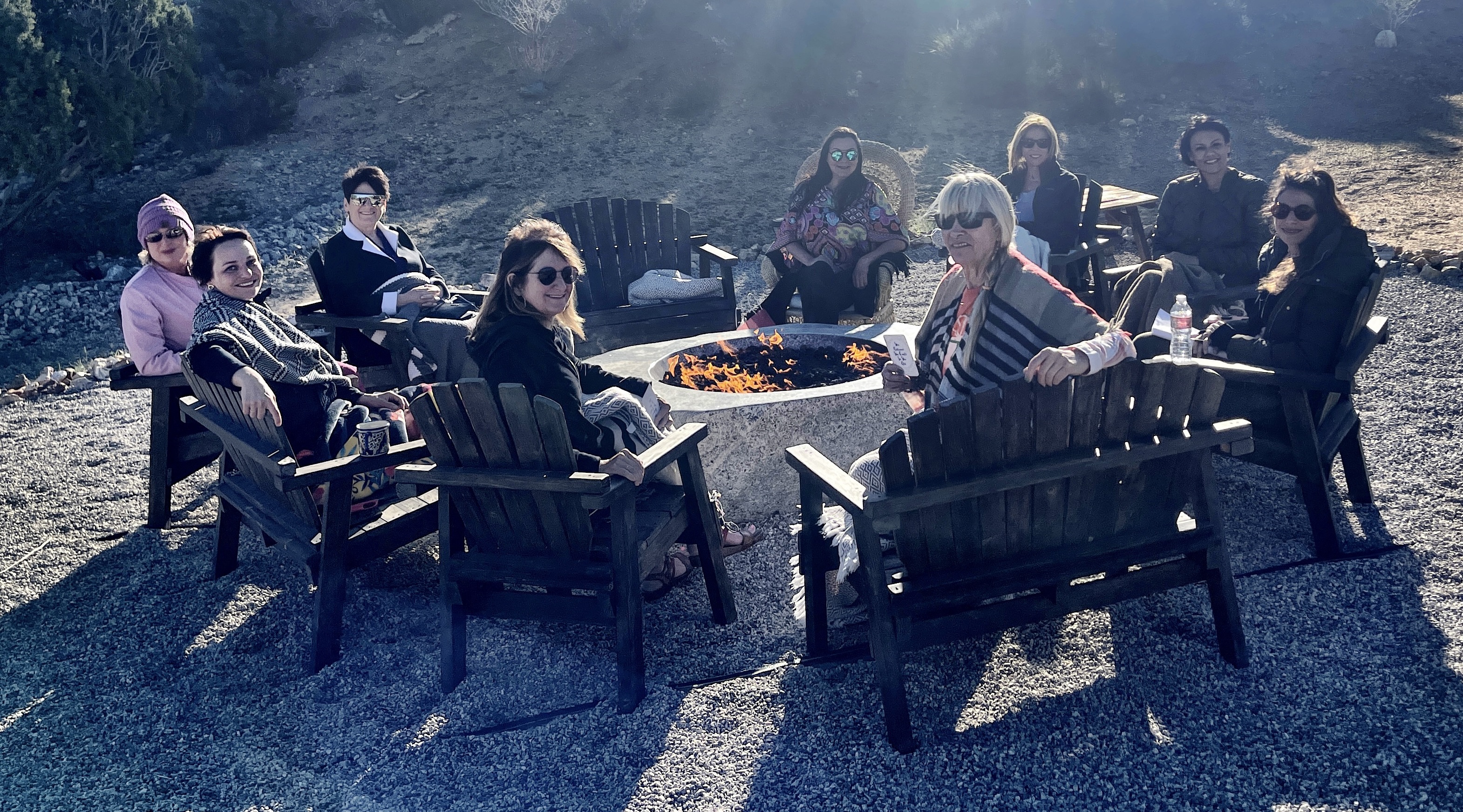 The circle gathered around the boulder fire pit