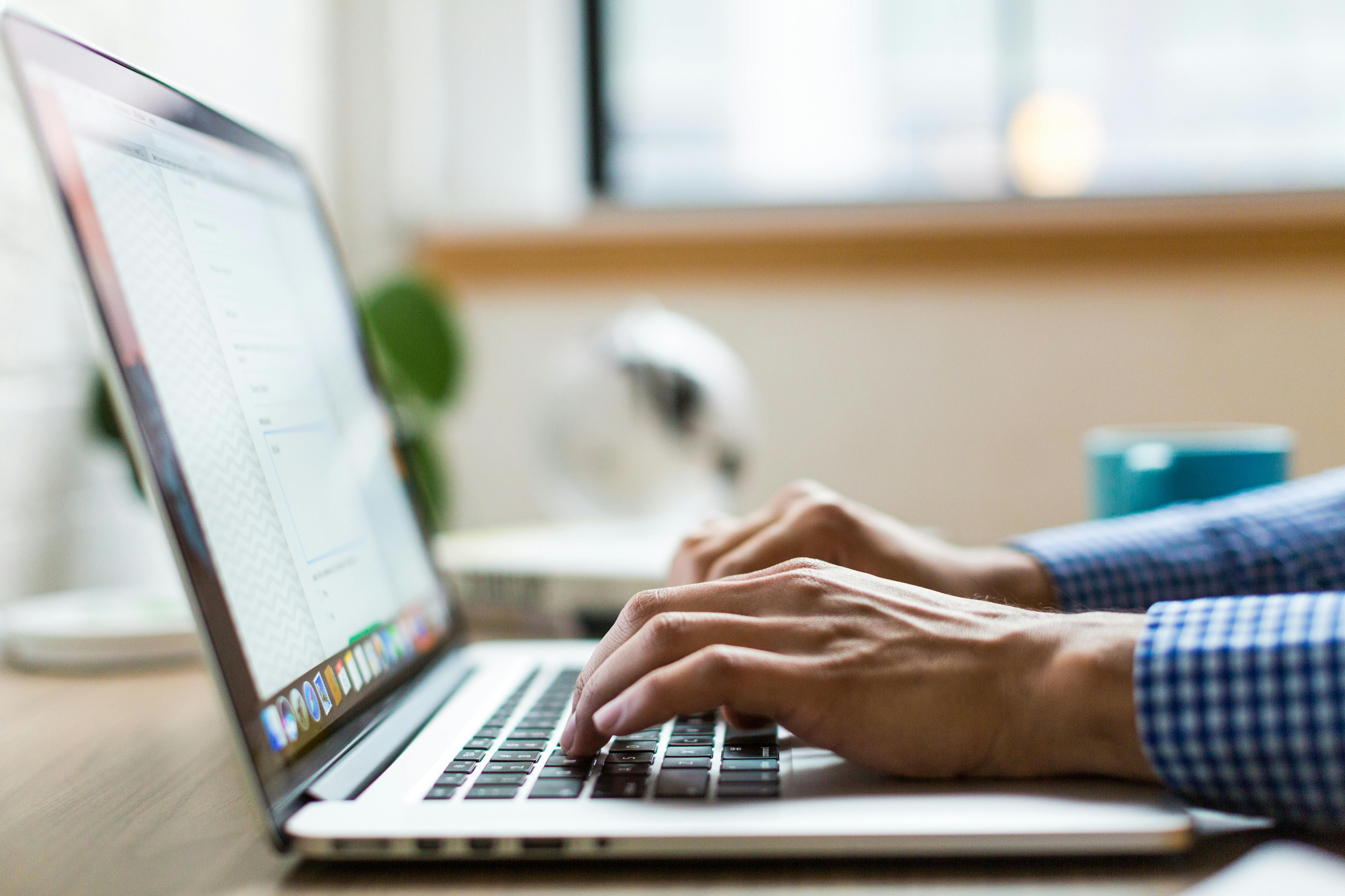 A man typing in the laptop