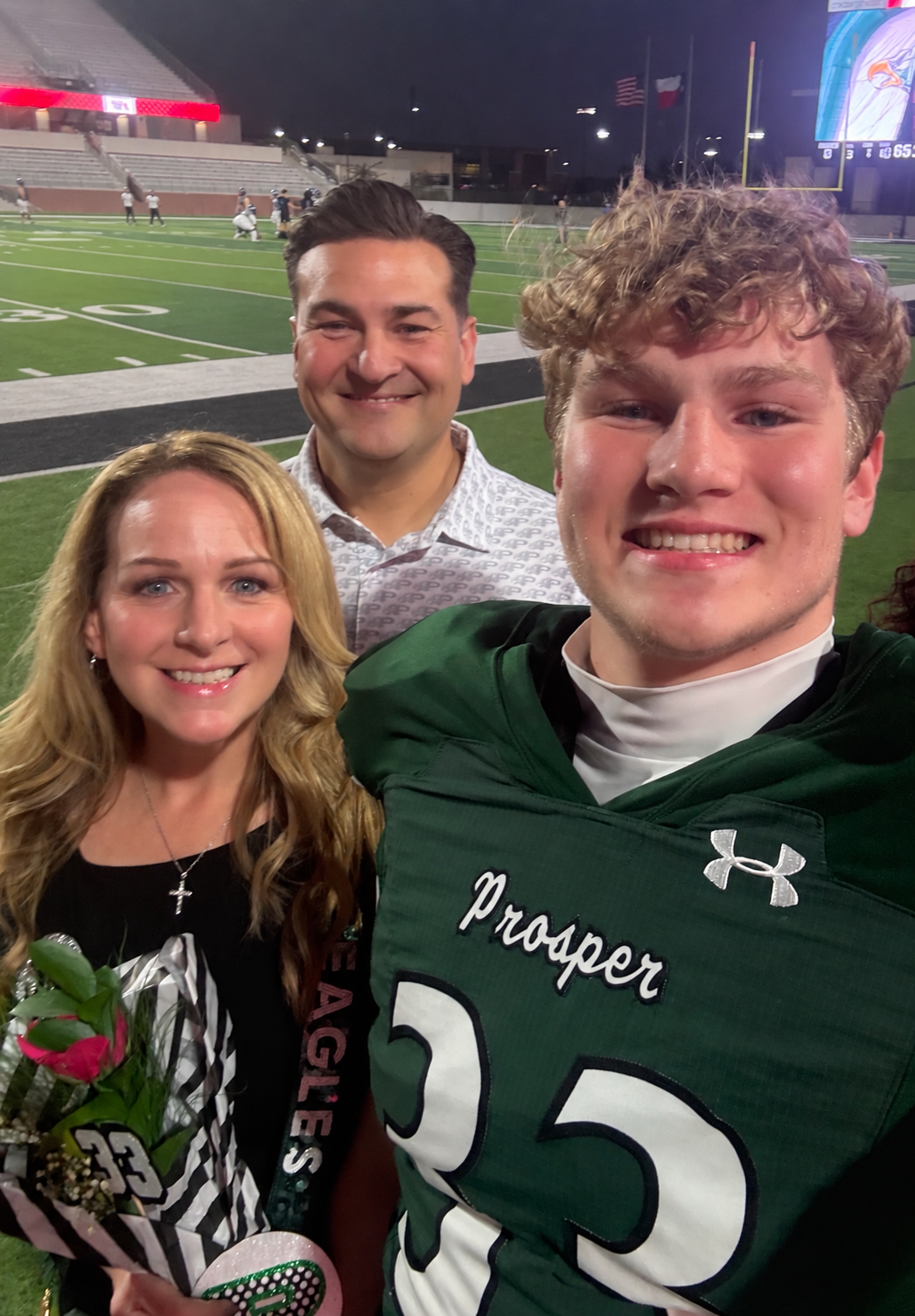 Rob and Lynne Alfano with their son Justin on the field