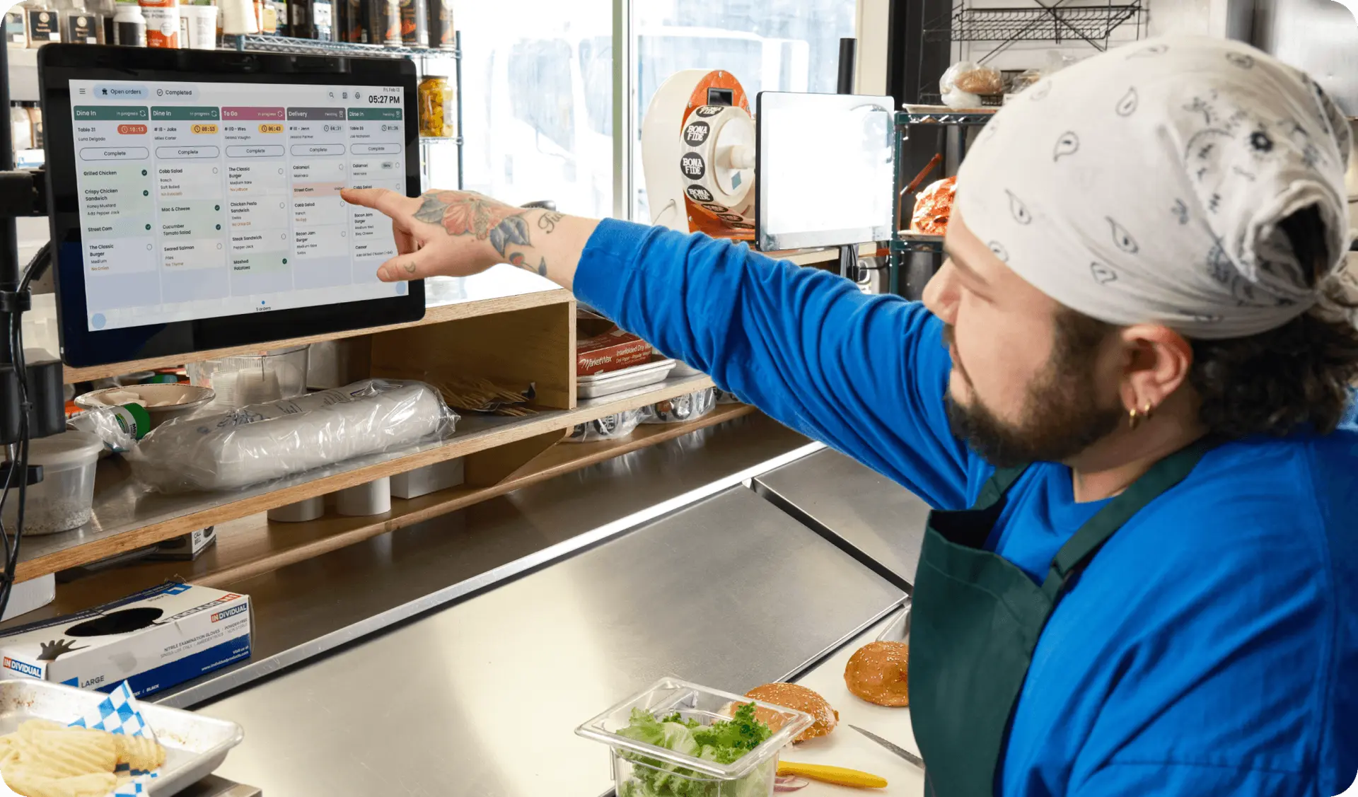 SpotOn kitchen display system showing routed orders in a restaurant kitchen