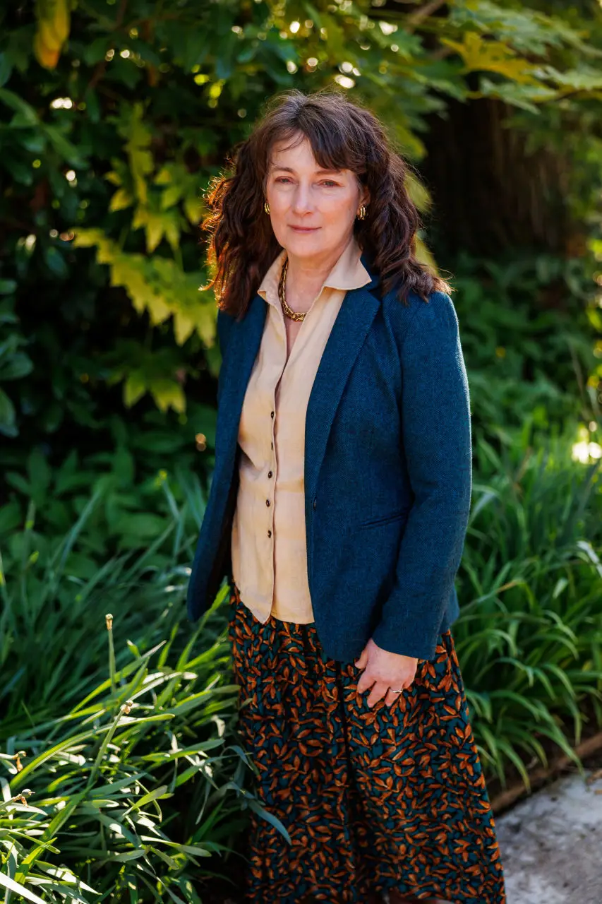 Dr. Robin Schaefer standing outside among greenery