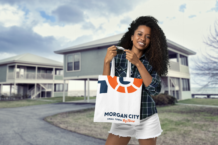 Morgan City tote bag with the Big Flavor slogan, a lifestyle application held by a community resident