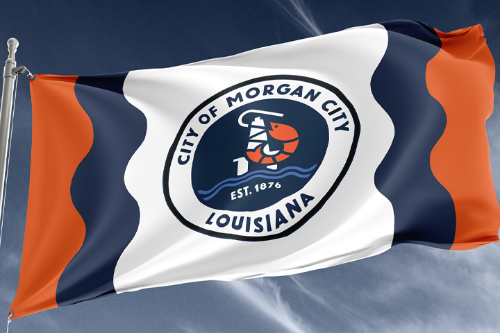 Morgan City flag flying on a flagpole, featuring the new identity mark on a wave pattern in navy, orange, and white, the brand applied at full civic scale