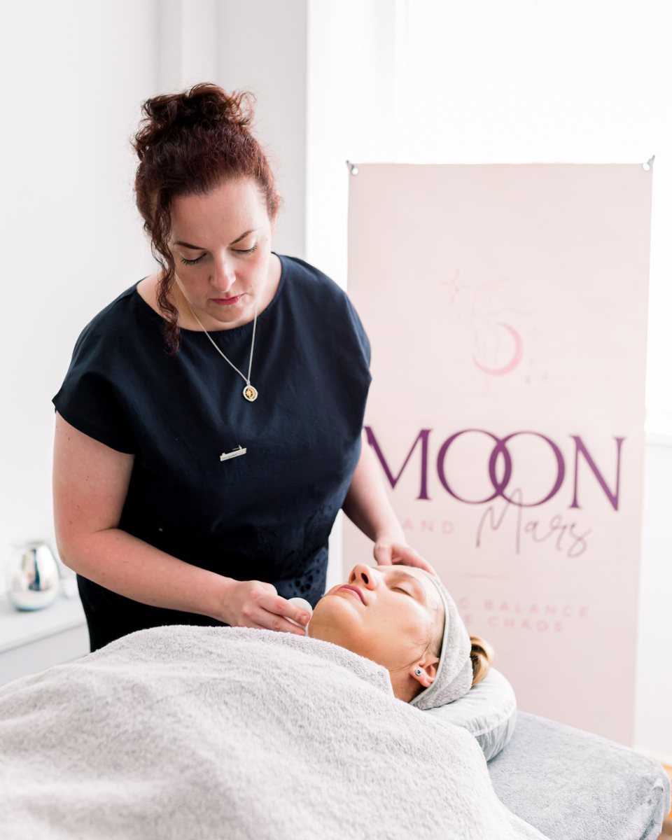 Michelle giving a holistic treatment in her Moon & Mars treatment room