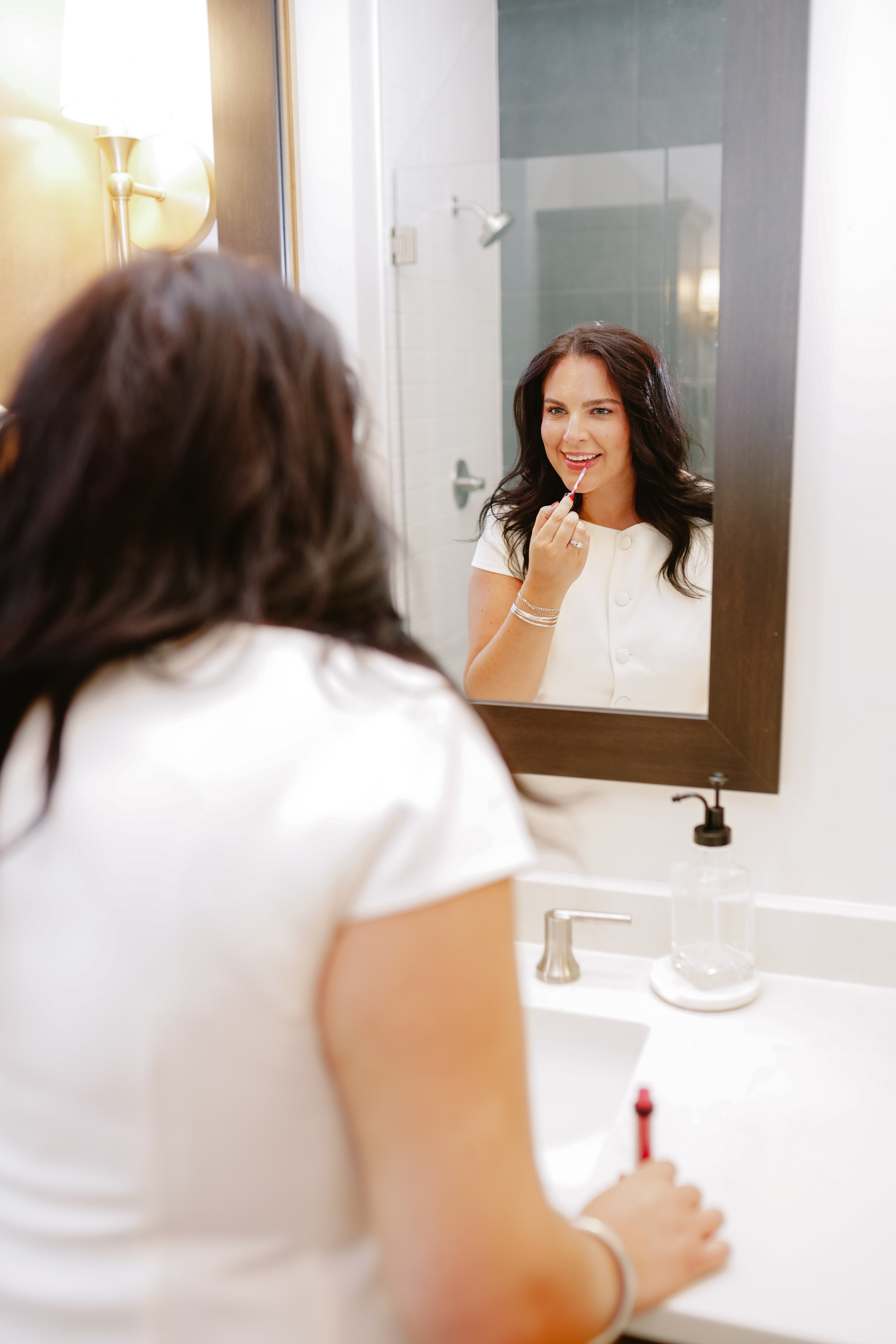 Taylor McAllister realtor KW anniston putting on lip gloss in mirror Taylor McAllister realtor KW anniston putting on lip gloss in mirror