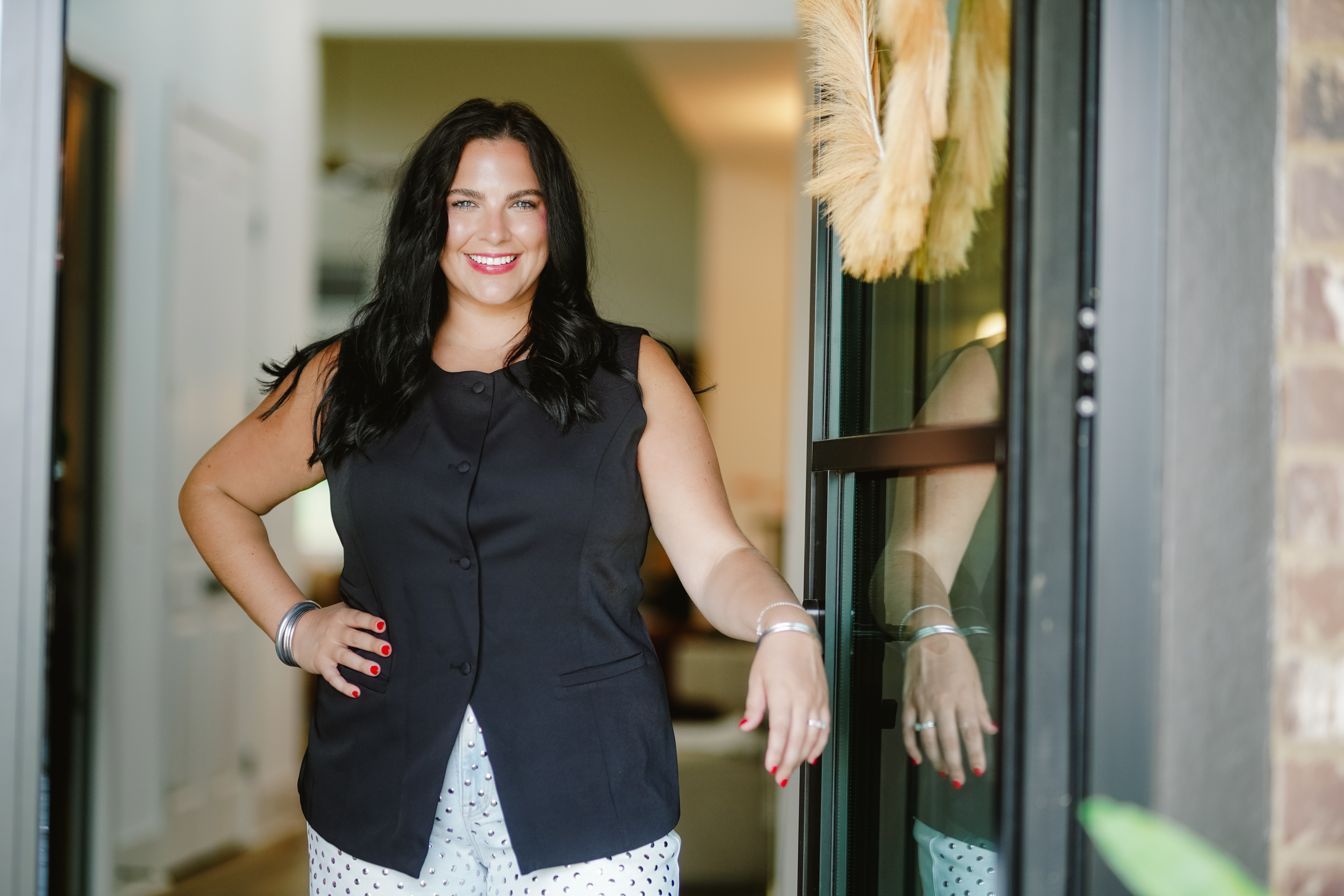 Taylor McAllister real estate agent in doorway smiling at the camera Taylor McAllister real estate agent in doorway smiling at the camera