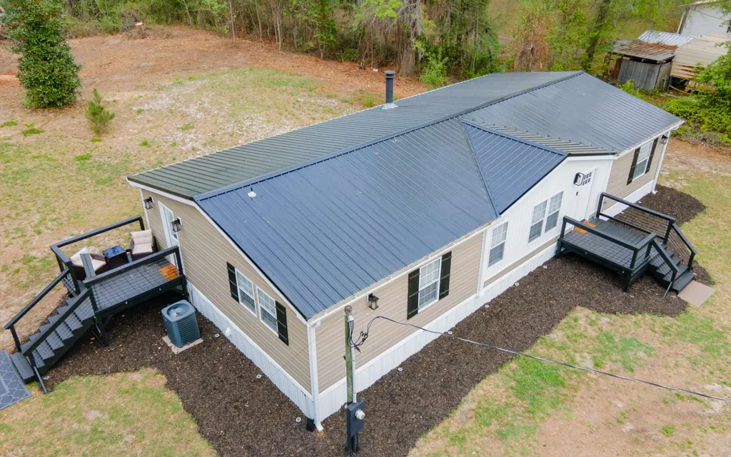 Aerial view of 1103 NW Moore Road showing the metal roof that was replaced in 2026