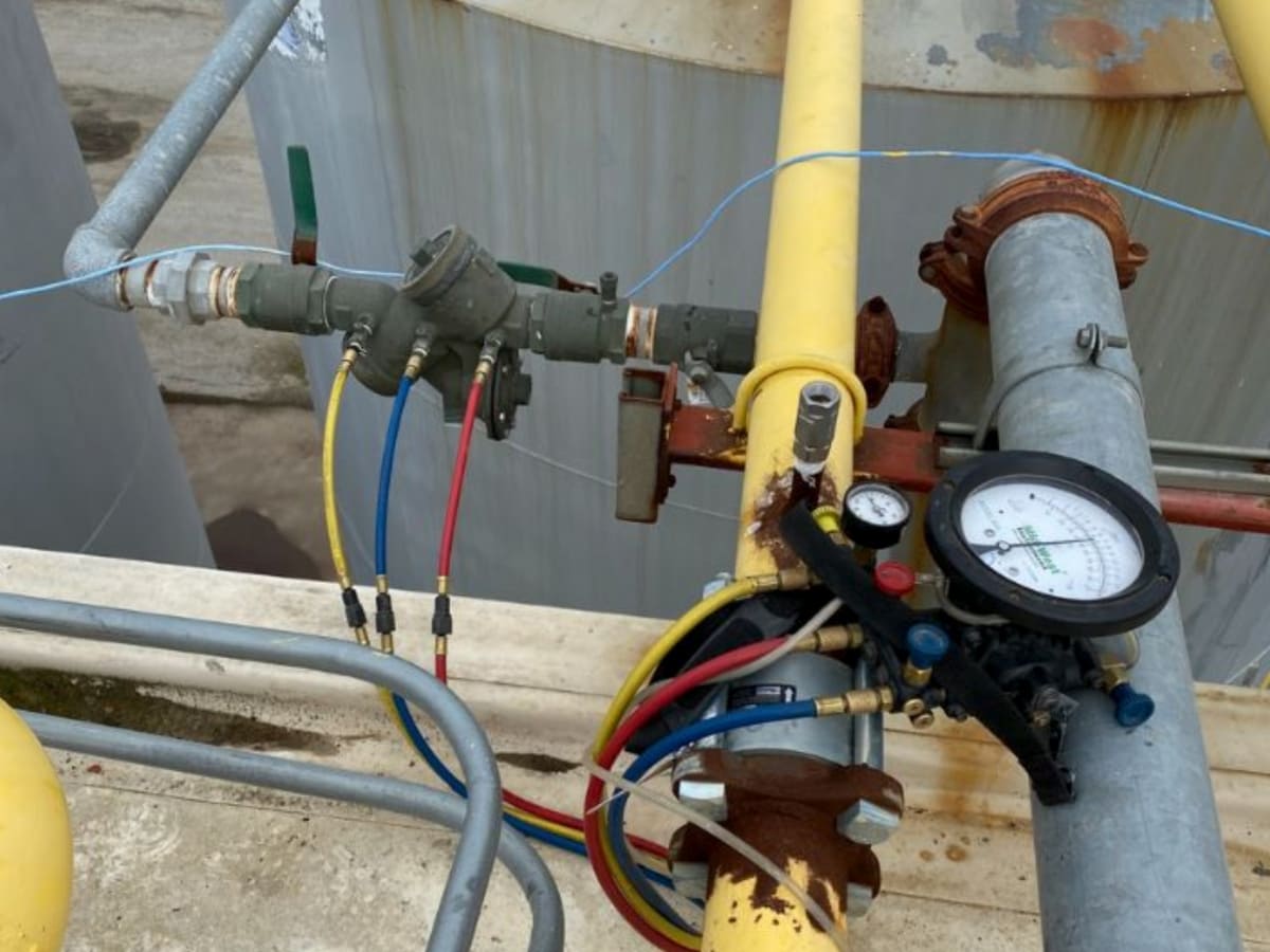 Close-up view of a rooftop backflow prevention system with monitoring equipment to ensure compliance and water safety.