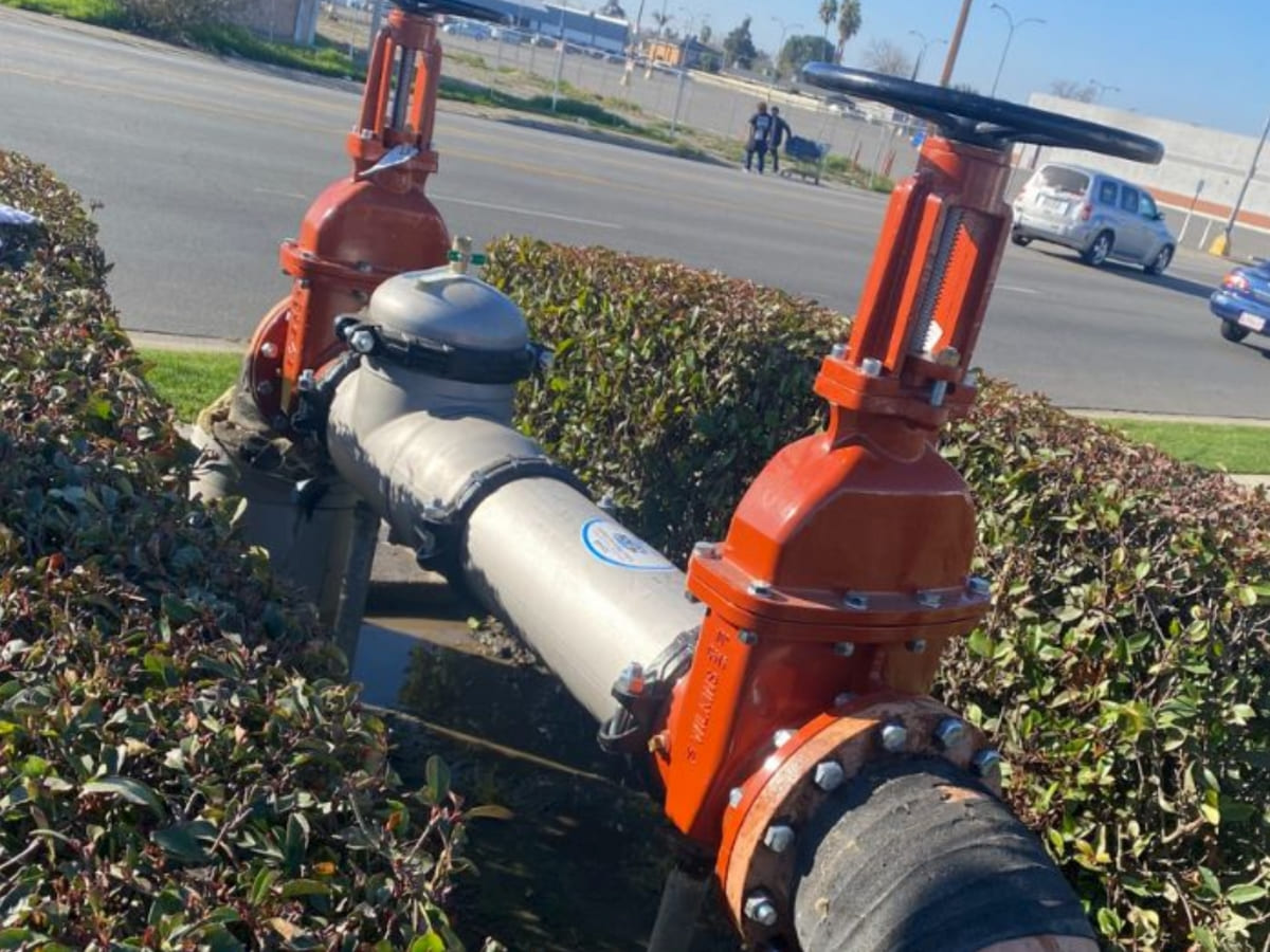 Backflow preventer system installed near the roadside, ensuring the integrity of water systems and contamination prevention.